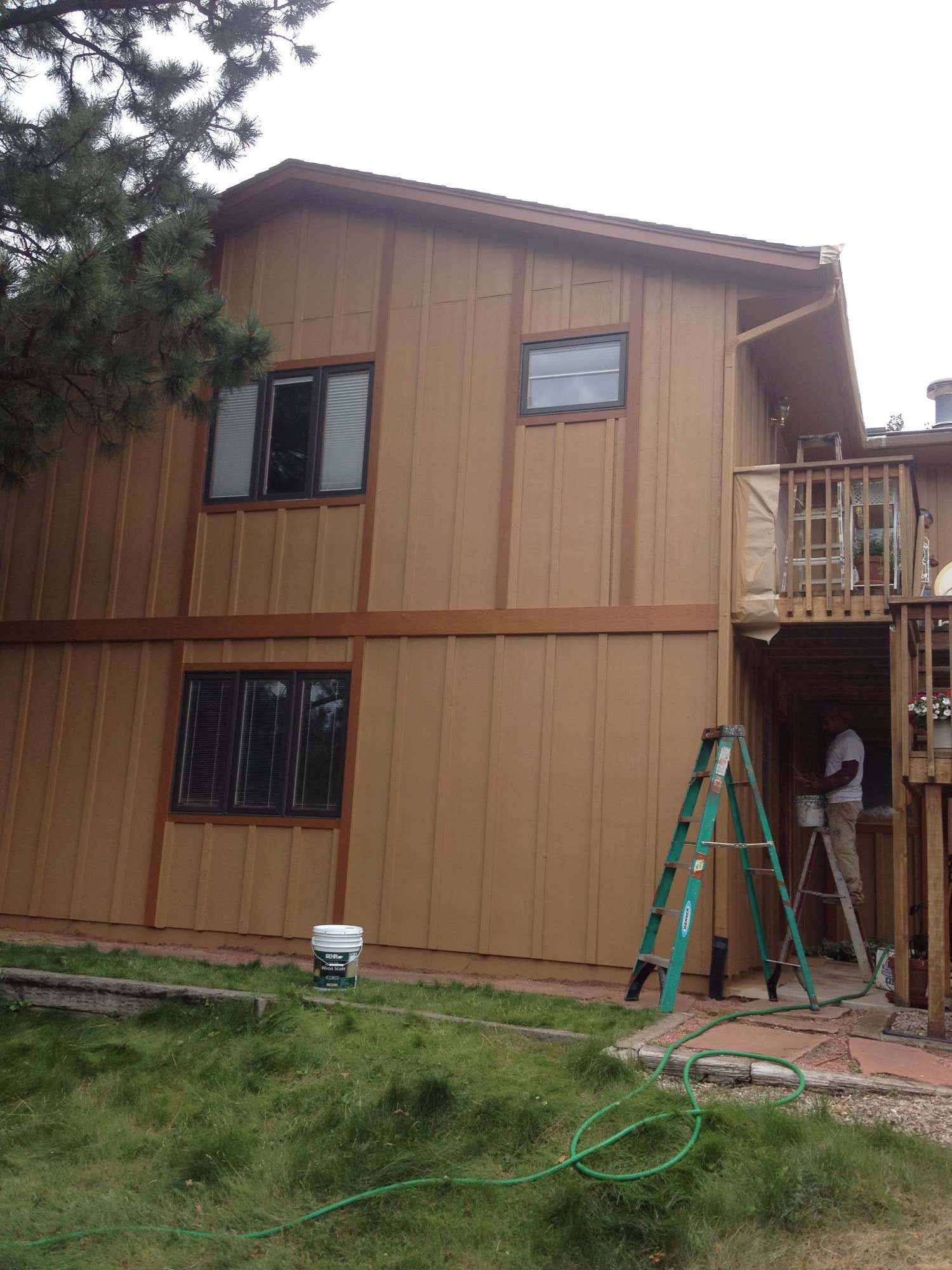 After: board-and-batten home in a warm caramel finish