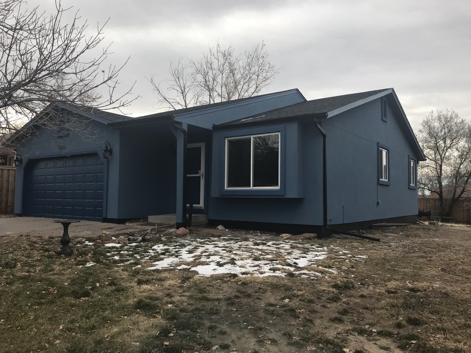 Slate-blue ranch home with refreshed exterior coating